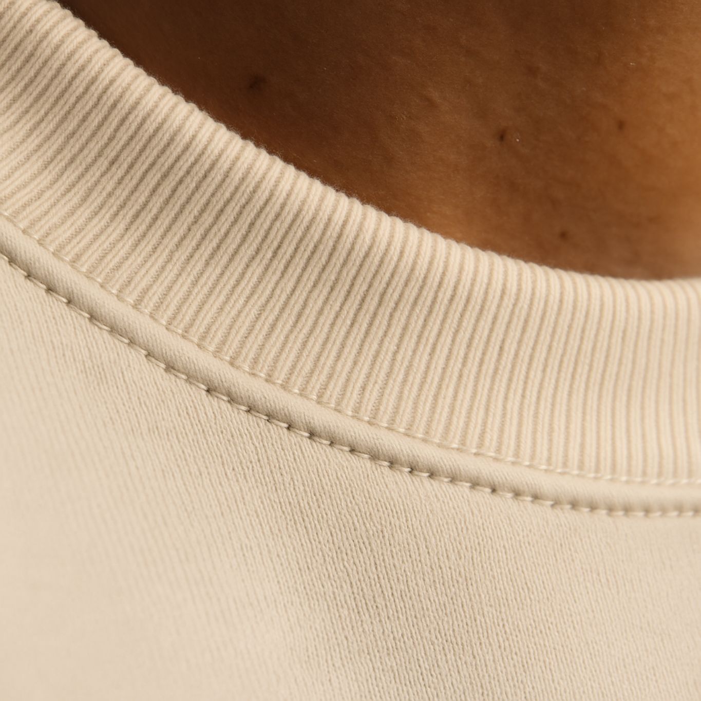 Macro detail of FineAF EMPATH sweatshirt neckline, showcasing smooth collar finish and double-stitched seams