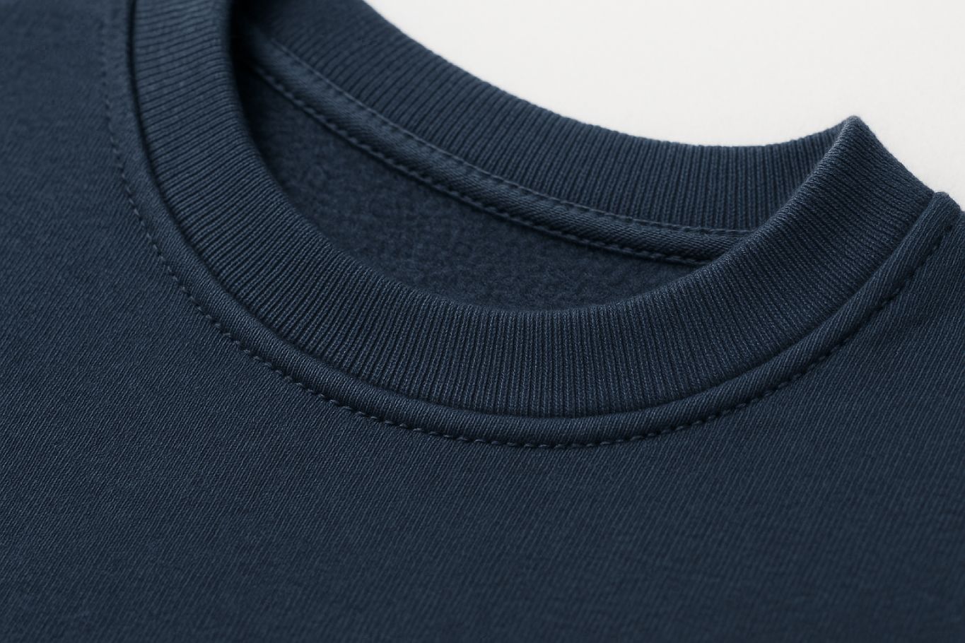 Close-up of FineAF CONFIDENT sweatshirt collar — smooth self-fabric finish, navy organic cotton texture.