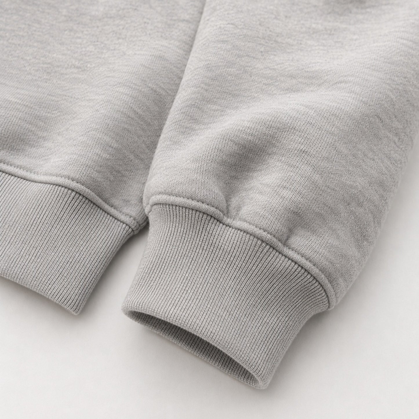 Close-up of the heavyweight sleeve and ribbed cuff on the FineAF Magnetic heather grey hoodie