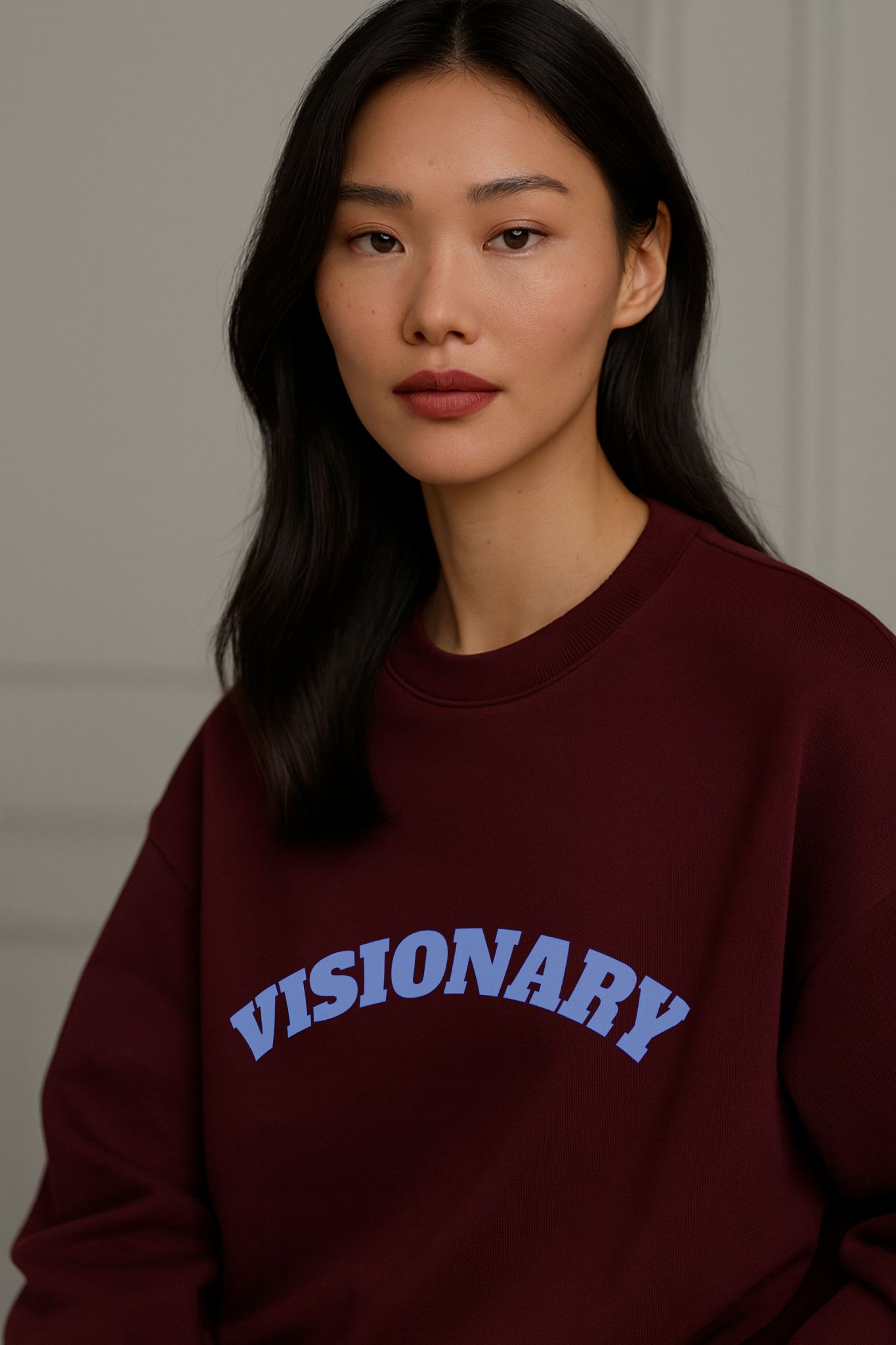 Model wearing FineAF VISIONARY burgundy sweatshirt, organic cotton fleece with soft matte texture.
