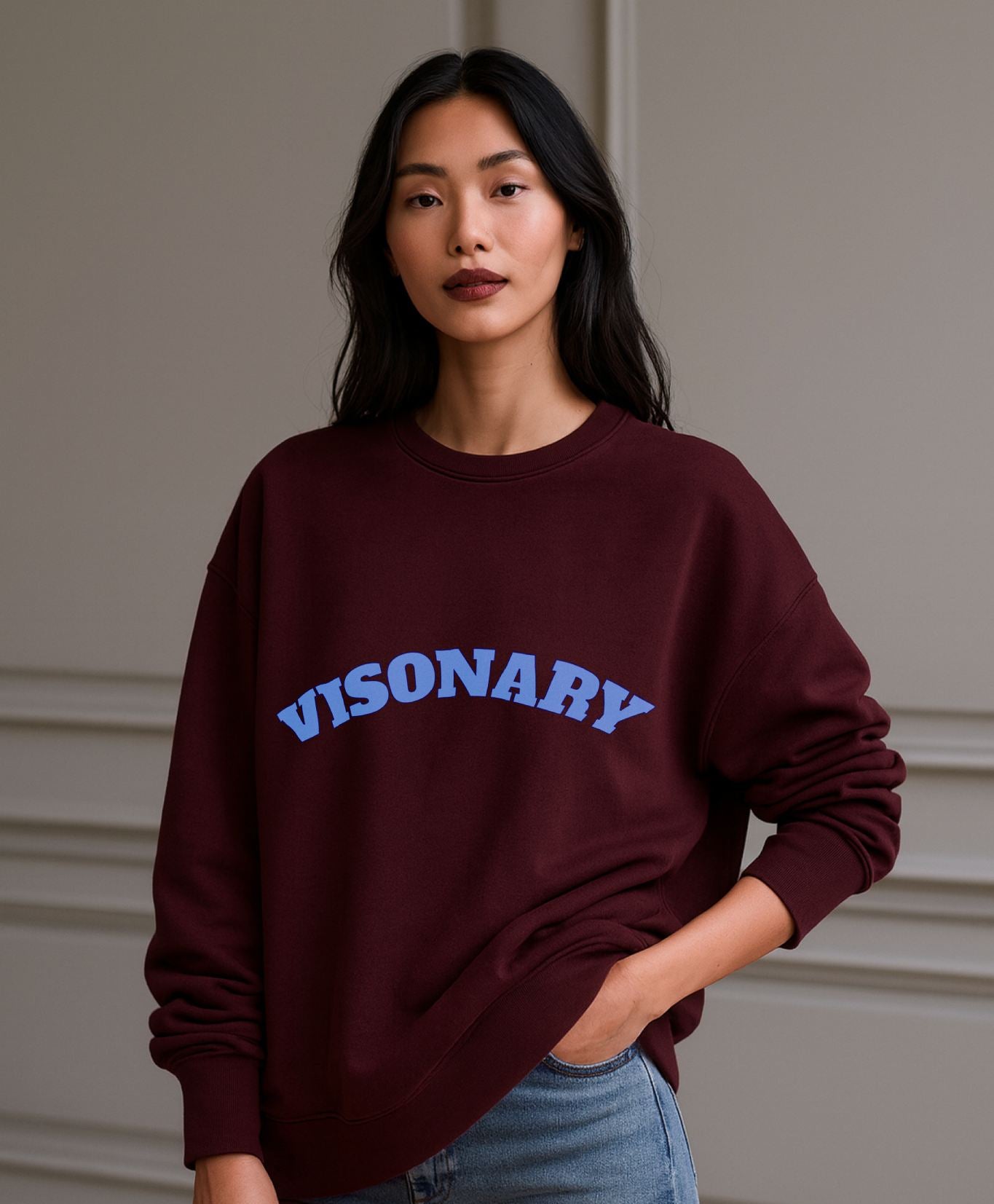 Model in FineAF VISIONARY burgundy sweatshirt, slow fashion organic cotton design styled with denim.