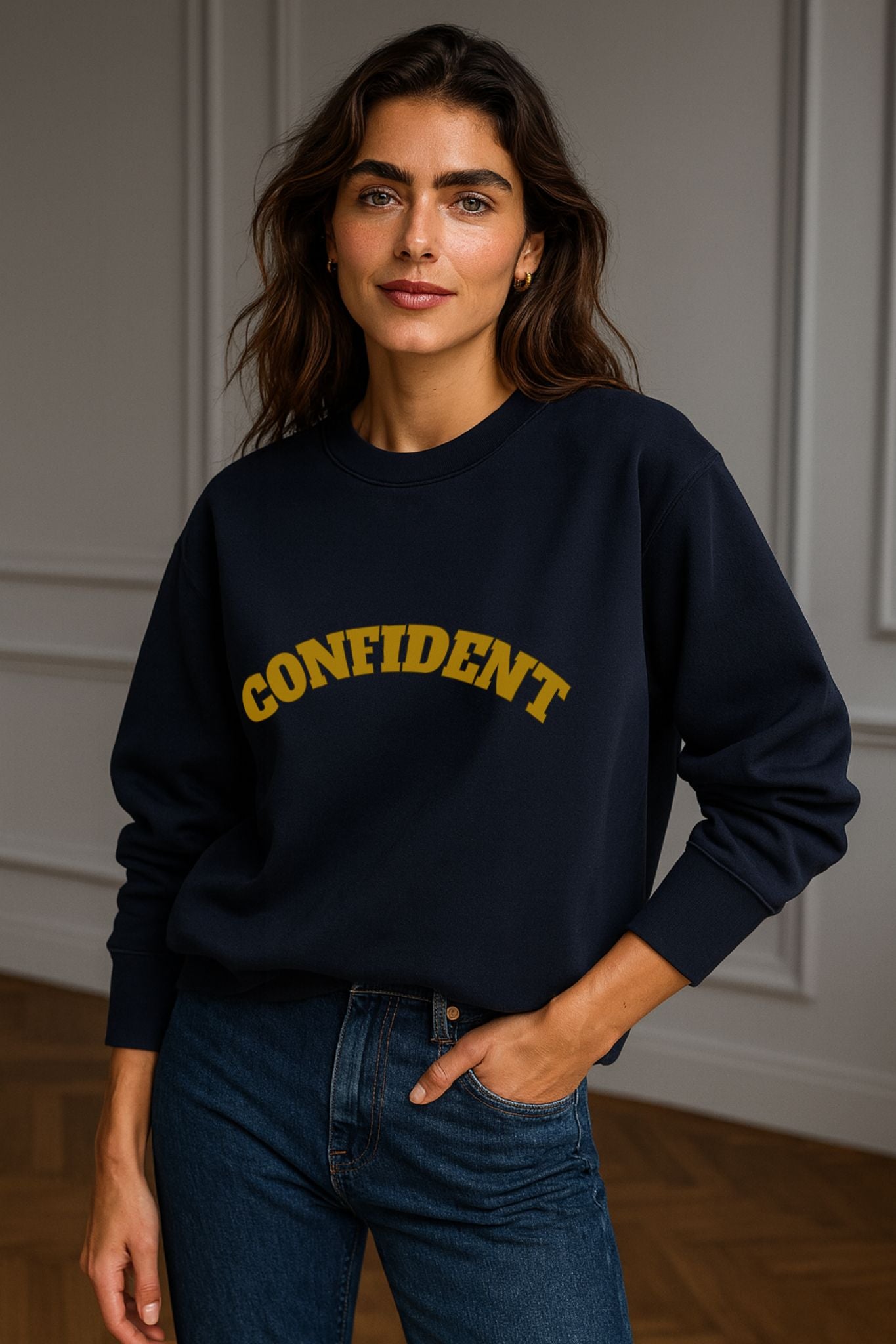 Model wearing FineAF CONFIDENT sweatshirt in navy — unisex organic cotton crewneck, minimalist design with gold arched lettering.