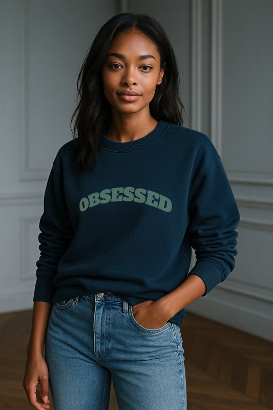 Model wearing FineAF OBSESSED sweatshirt in blue-teal organic cotton fleece, straight unisex fit.