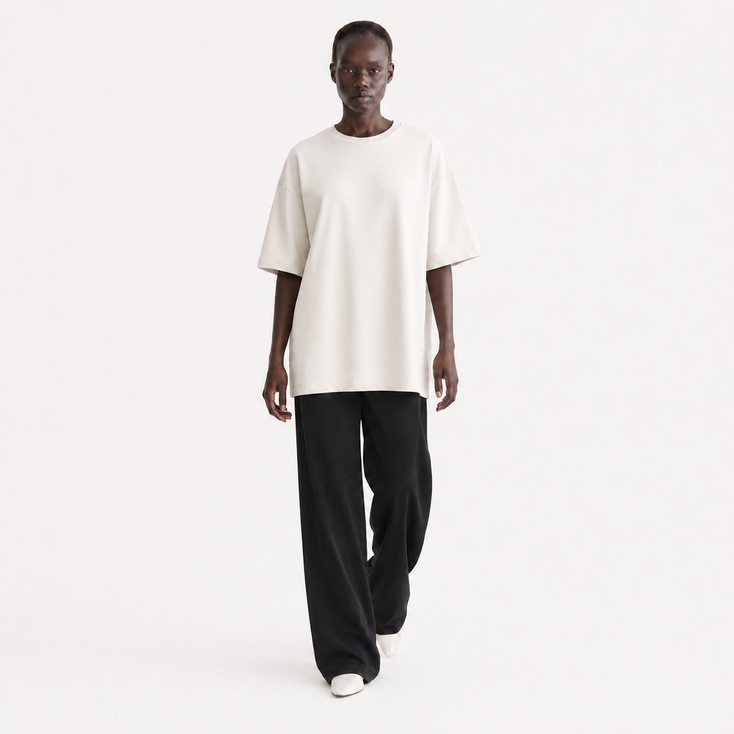 FineAF Collection One heavyweight drop-shoulder T-shirt in Oat, movement pose on model