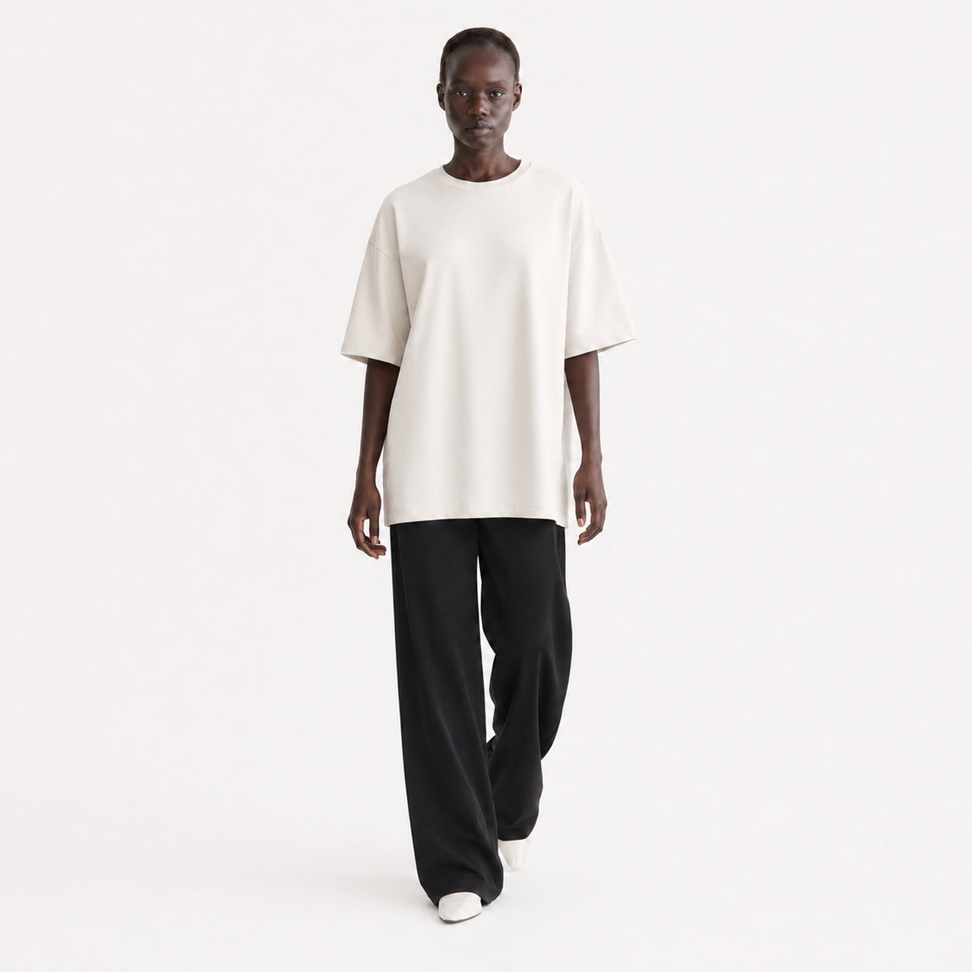 FineAF Collection One heavyweight drop-shoulder T-shirt in Oat, movement pose on model