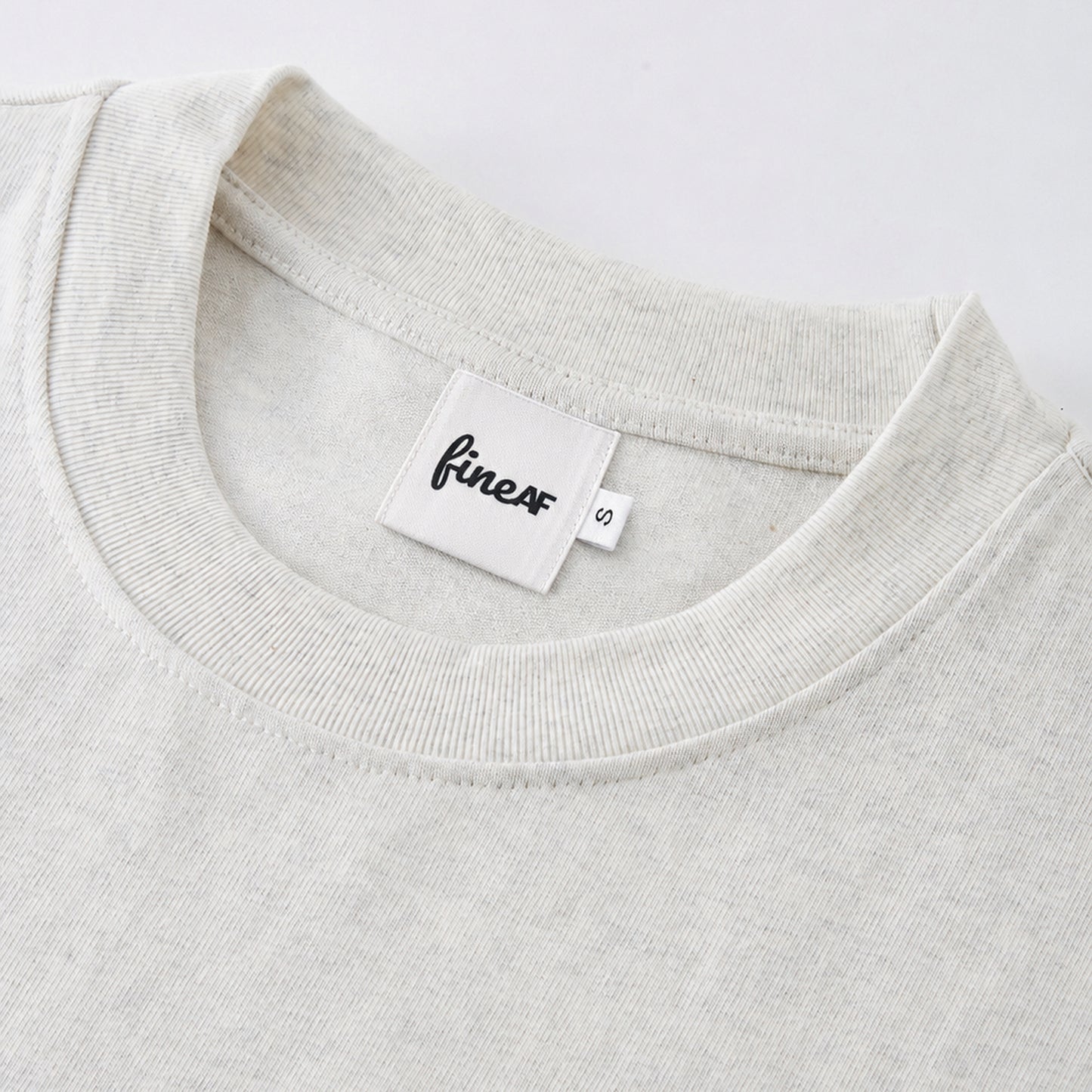 FineAF Oat heavyweight T-shirt neckline and FineAF label detail