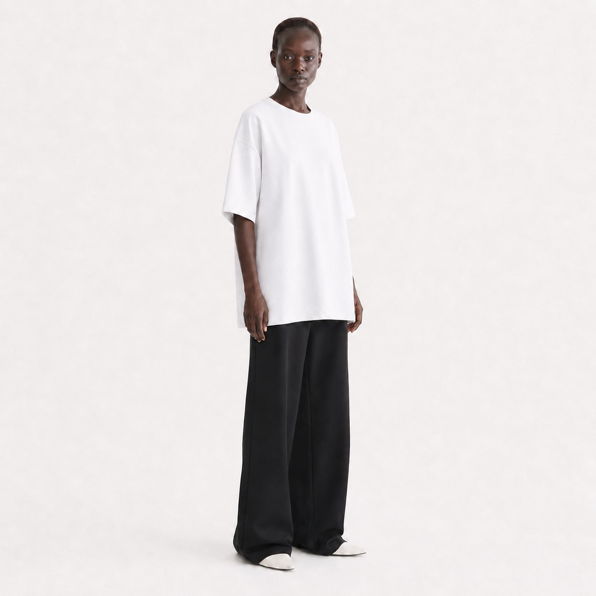 FineAF Collection One heavyweight drop-shoulder T-shirt in White, three-quarter view on model