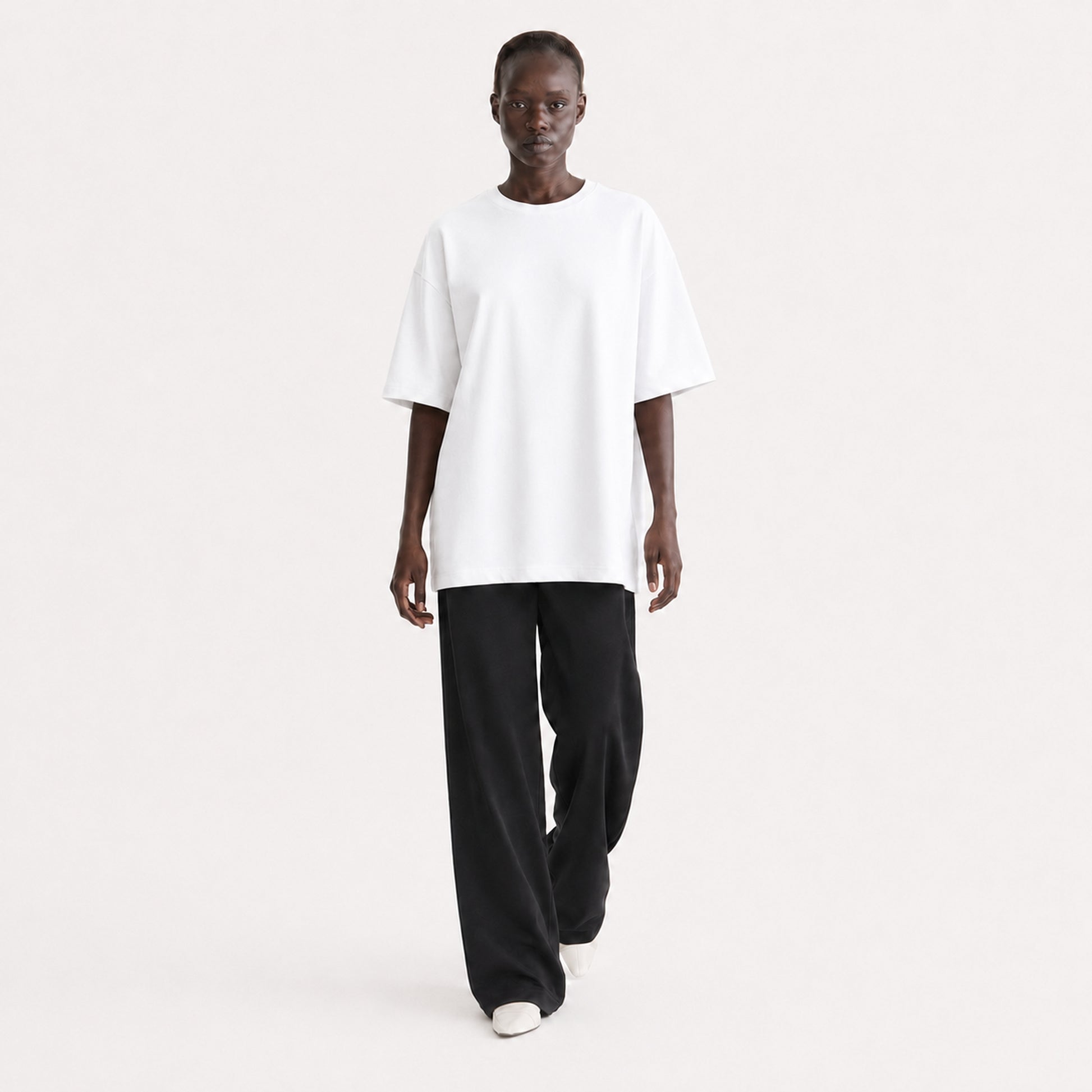 FineAF Collection One heavyweight drop-shoulder T-shirt in White, movement pose on model