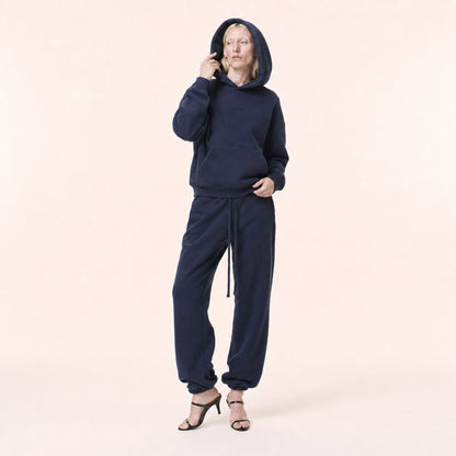 Woman wearing the FineAF Electric deep navy heavyweight hoodie with the structured hood up