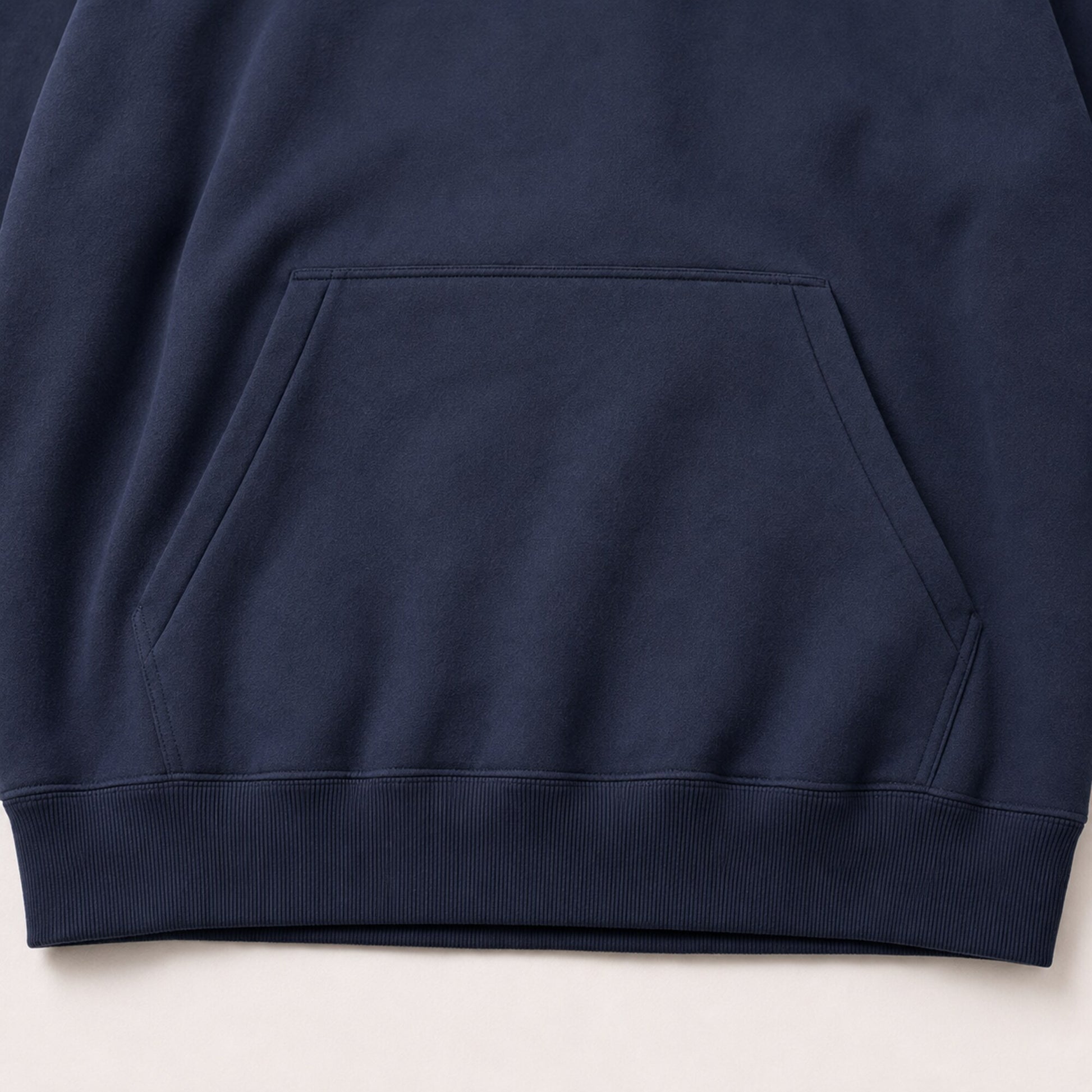 Close-up of the FineAF Electric hoodie shaped front pocket and thick ribbed hem