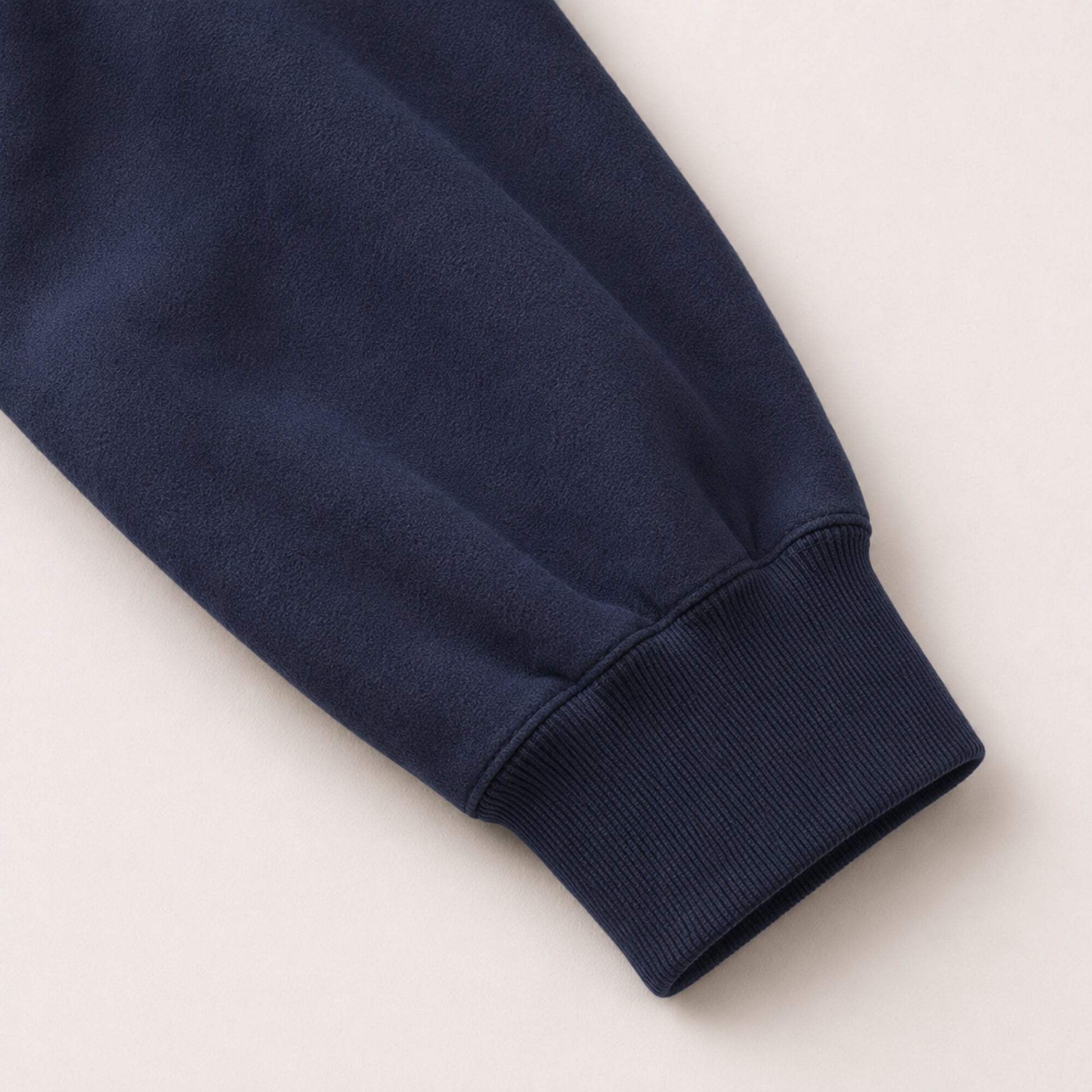 Close-up of the FineAF Electric hoodie sleeve volume and deep navy ribbed cuff