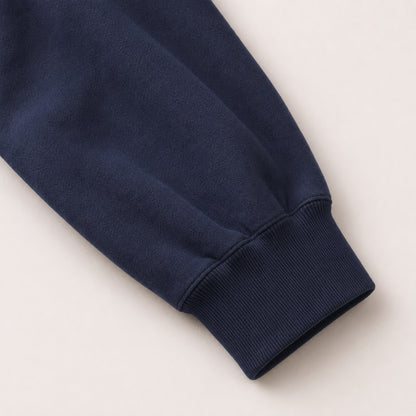 Close-up of the FineAF Electric hoodie sleeve volume and deep navy ribbed cuff