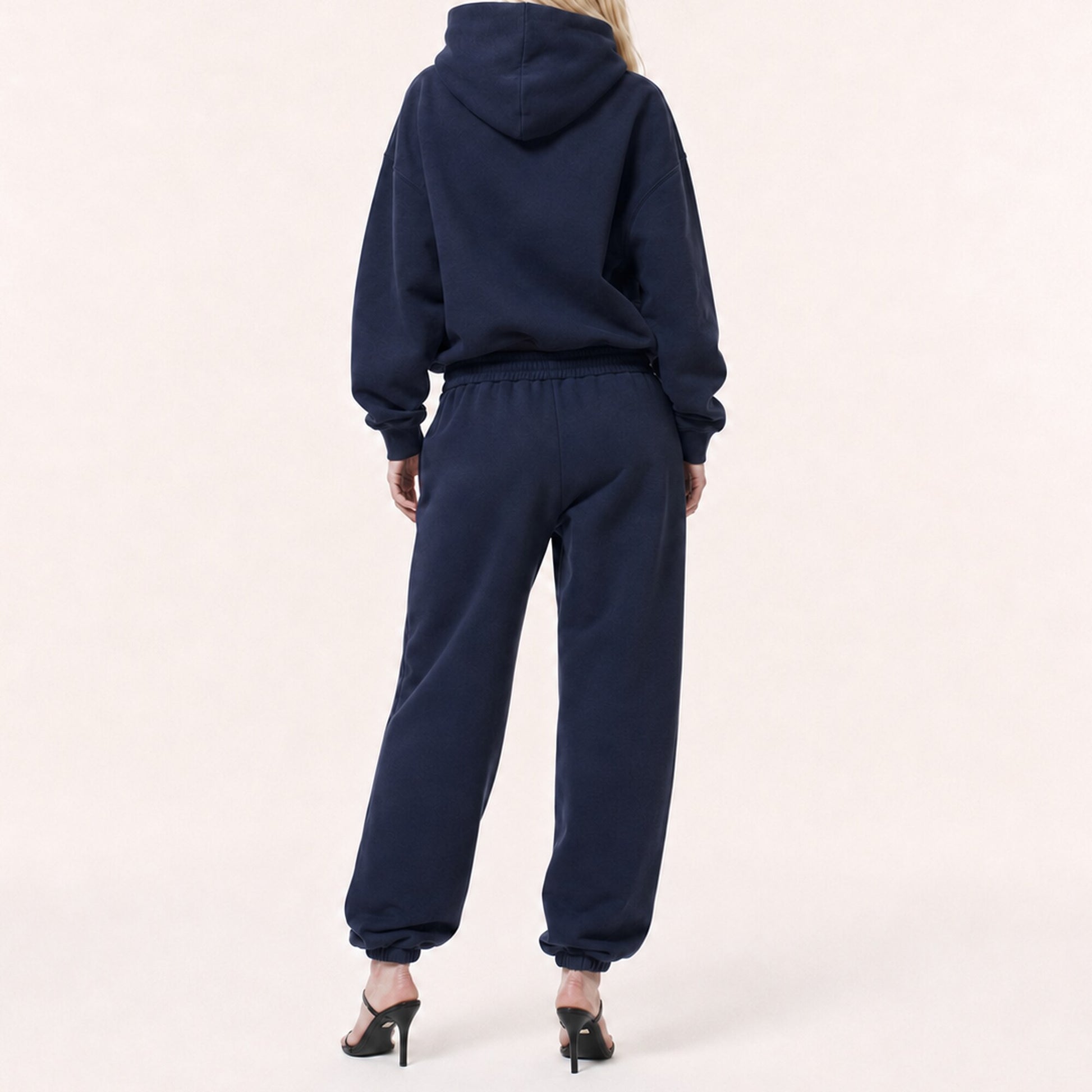 Back view of FineAF Electric deep navy pants showing the clean pocket-free seat, gathered waistband and tapered legs.
