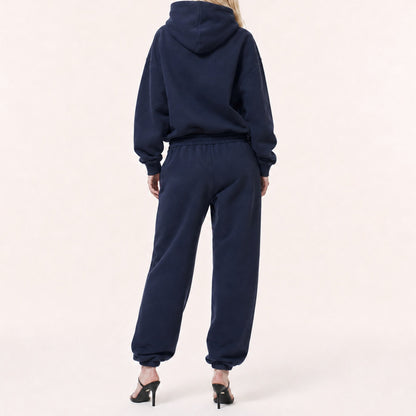 Back view of FineAF Electric deep navy pants showing the clean pocket-free seat, gathered waistband and tapered legs.