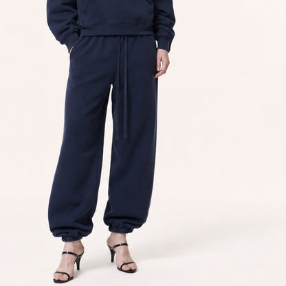 Waist-to-shoe crop of FineAF Electric deep navy pants with tonal drawcord, welt pockets and gathered elastic ankles.