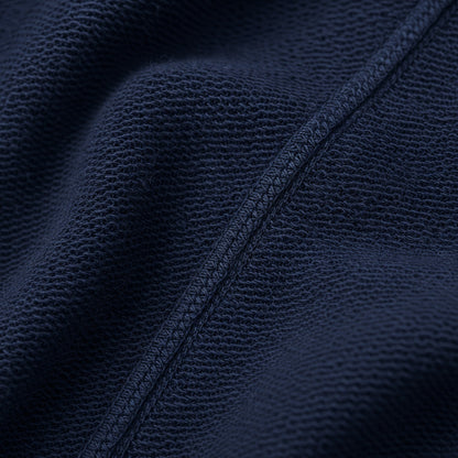 Macro of FineAF Electric navy loopback knit fabric and a tonal overlock construction seam.