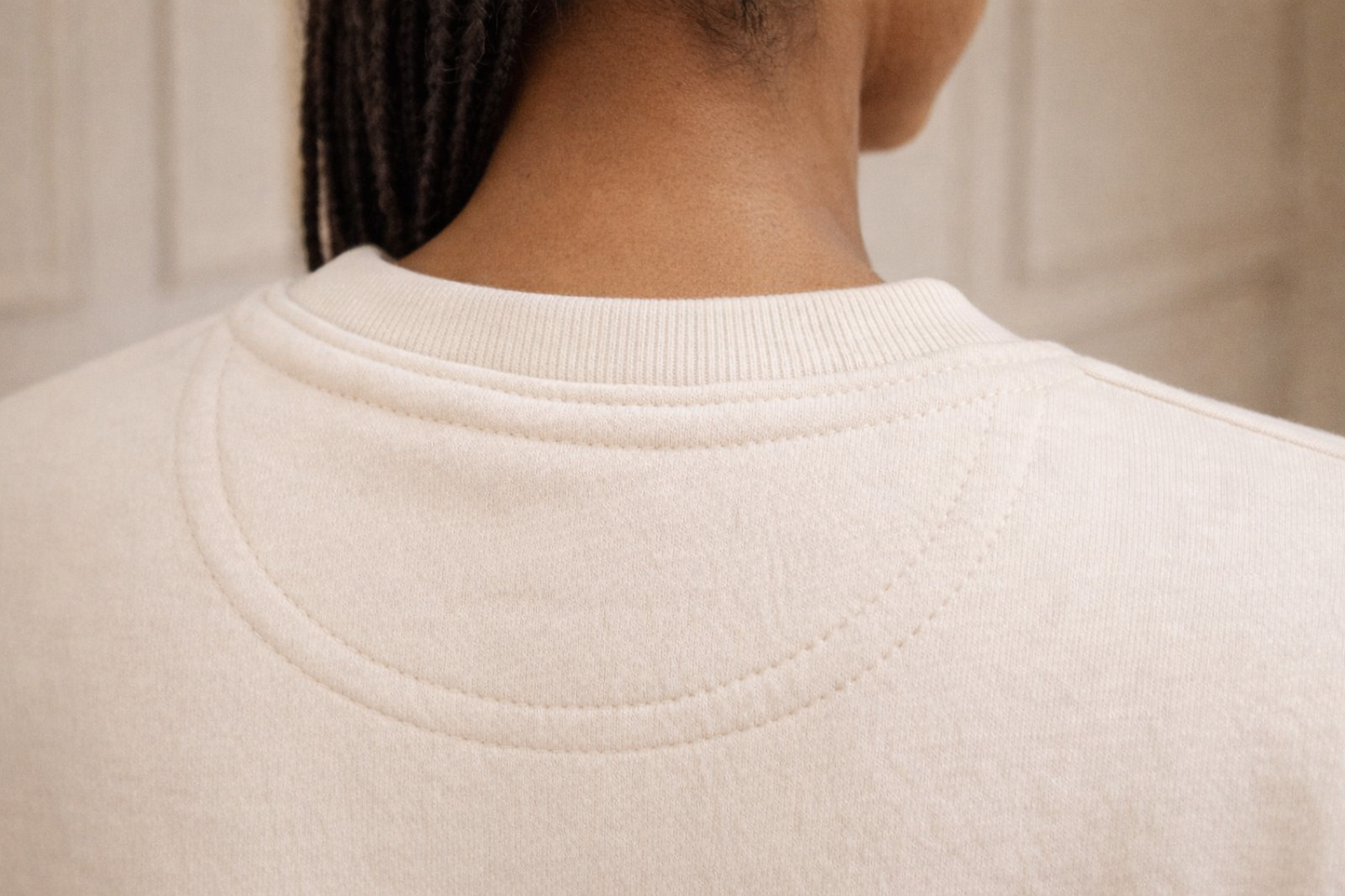 Ivory FineAF crewneck sweatshirt back neckline close-up showing ribbed collar and stitching.