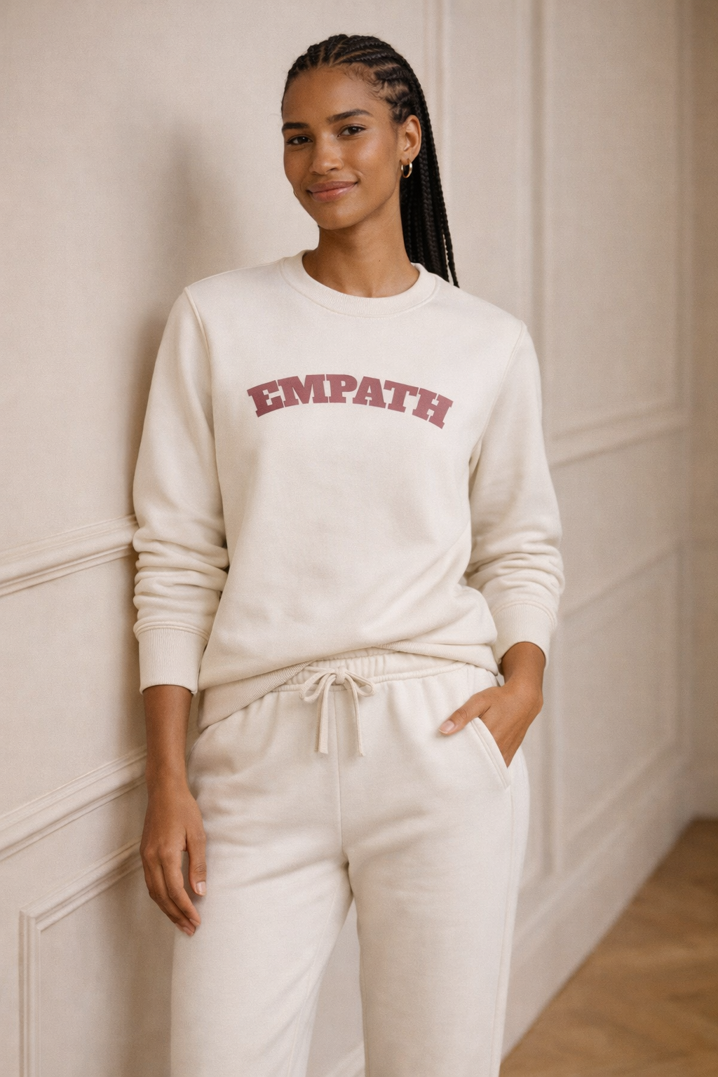 Ivory FineAF crewneck sweatshirt with “EMPATH” print, standing lifestyle photo on model.