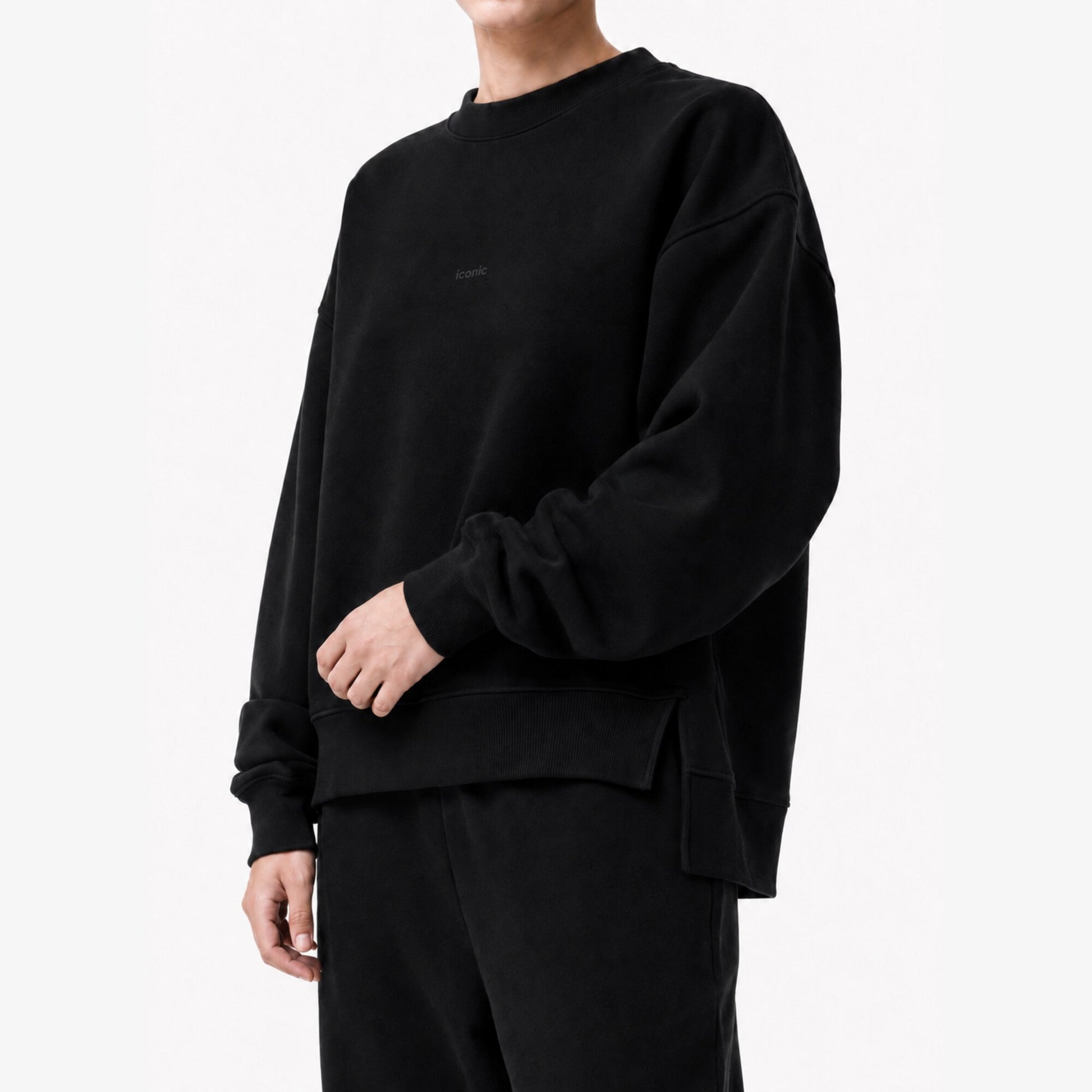 Close model view of the FineAF Iconic black sweatshirt showing the ribbed crewneck, tonal chest design and side-slit hem.
