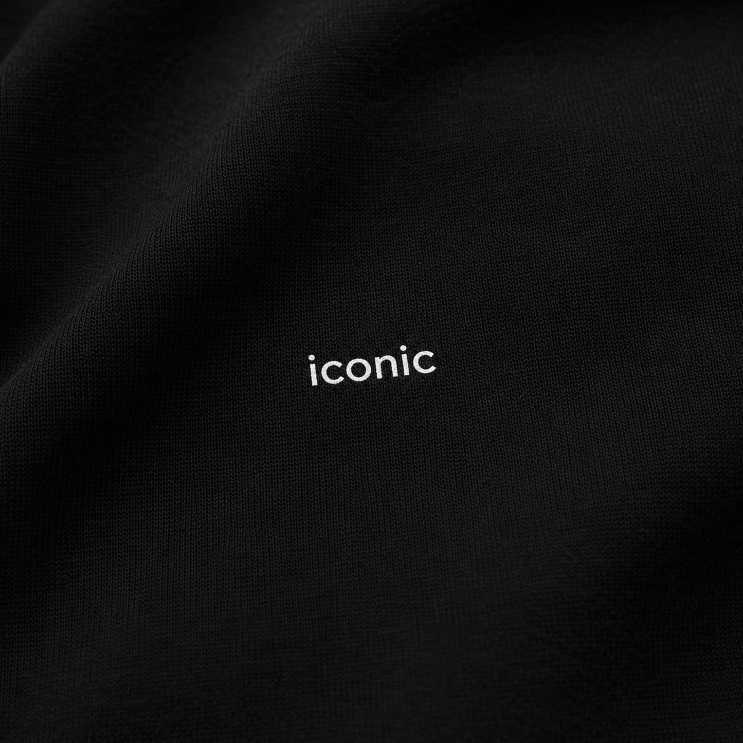 Close-up of the tiny tonal iconic design on the black FineAF heavyweight crewneck sweatshirt.