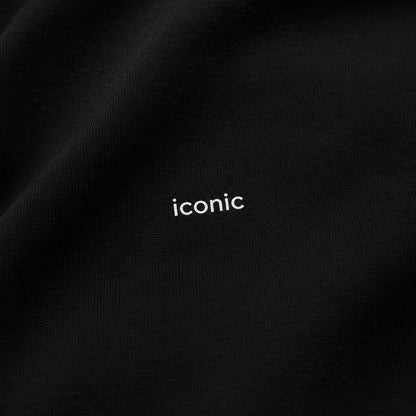 Close-up of the tiny tonal iconic design on the black FineAF heavyweight crewneck sweatshirt.