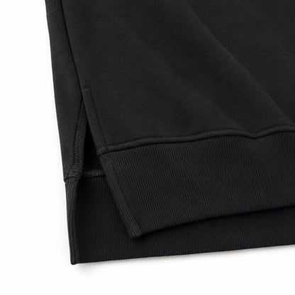 Close-up of the FineAF Iconic sweatshirt short side slit, ribbed front hem and longer rear hem.