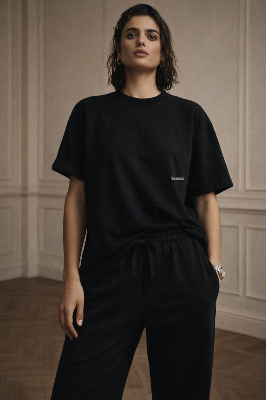 Black FineAF crewneck T-shirt with small chest logo, lifestyle front photo on model.