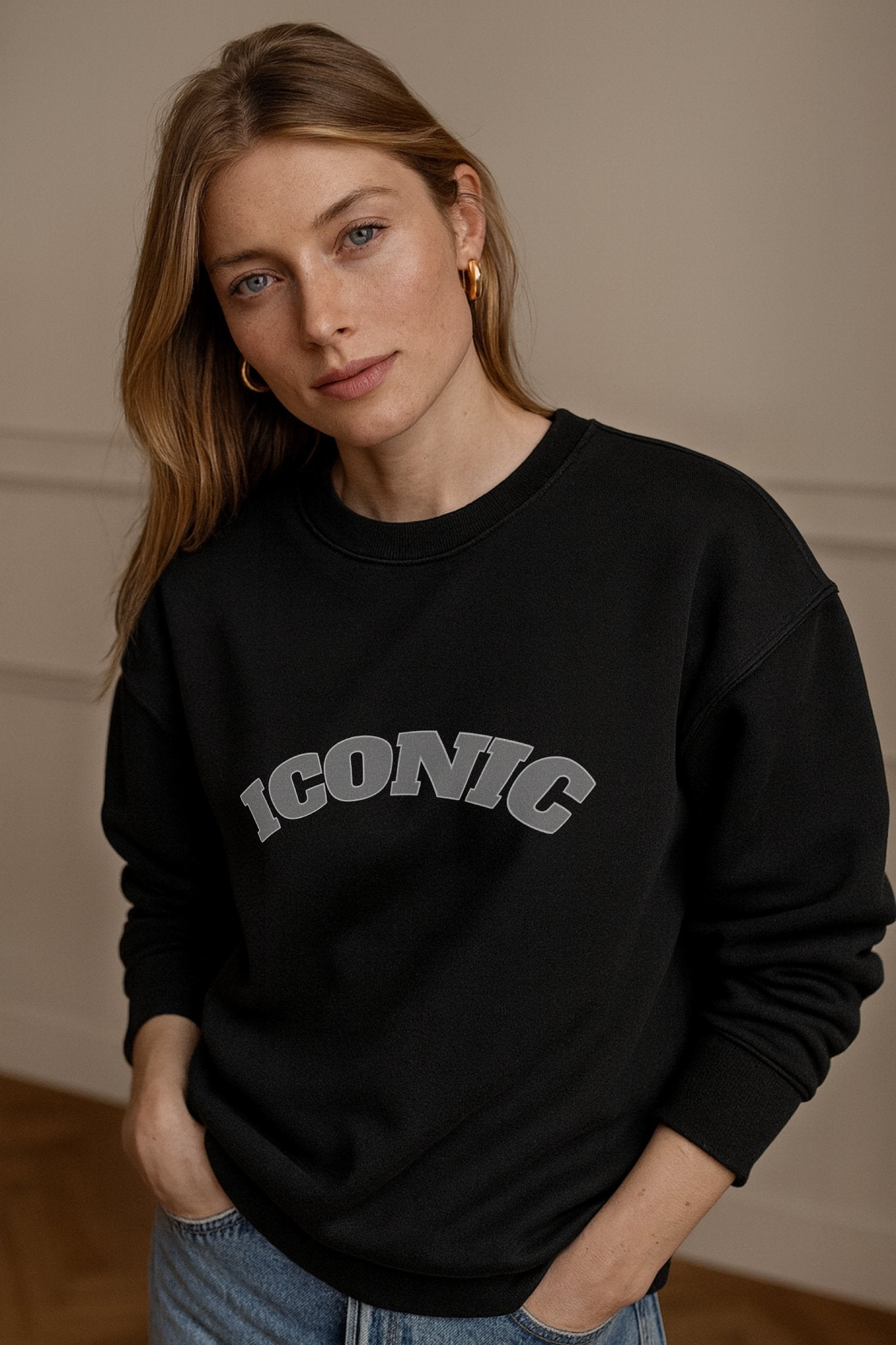Close up black ICONIC heavyweight organic cotton crewneck sweatshirt with relaxed unisex fit, worn in a daylight studio.