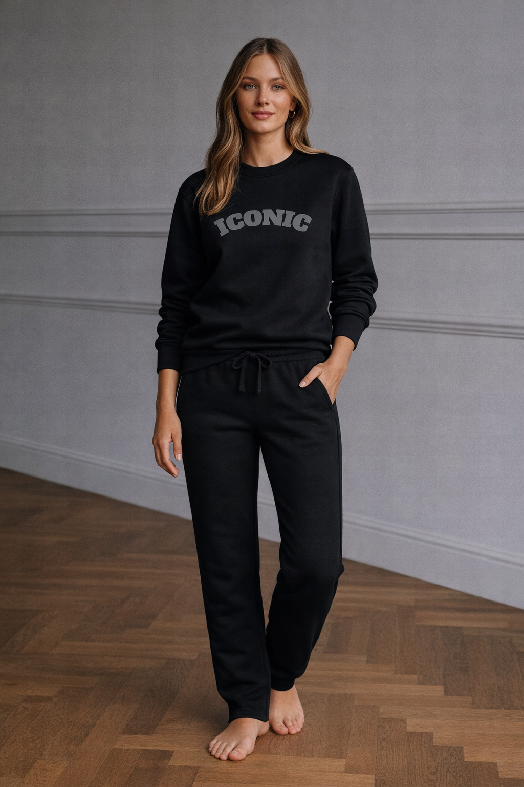 Black FineAF crewneck sweatshirt with “ICONIC” print, lifestyle full-body photo on model.