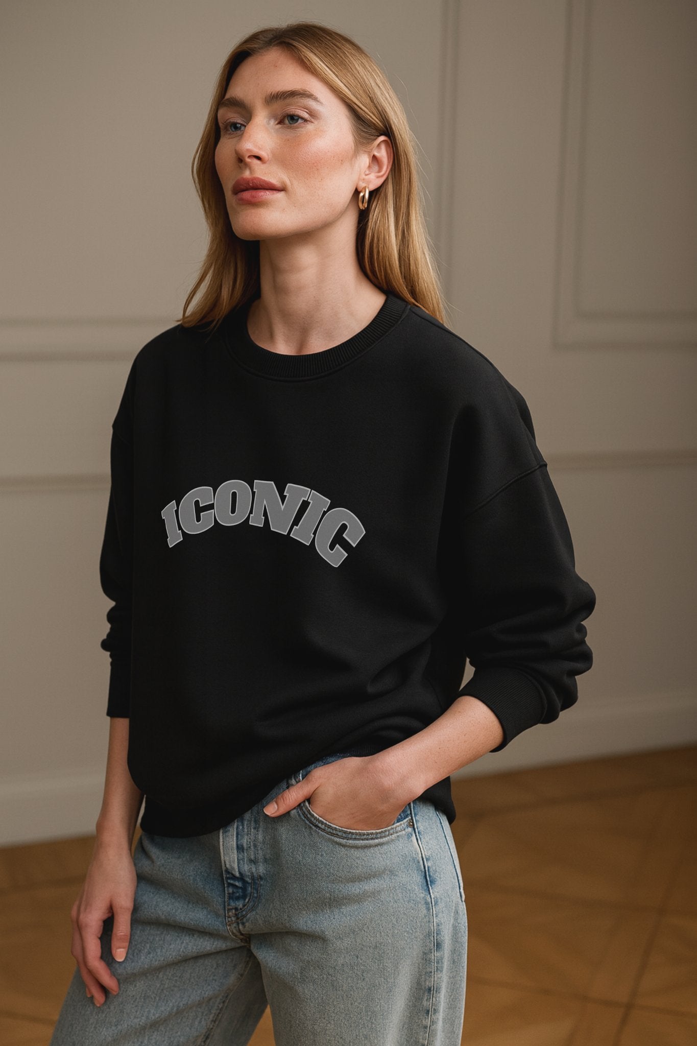 Black ICONIC heavyweight organic cotton crewneck sweatshirt with relaxed unisex fit, worn in a daylight studio.