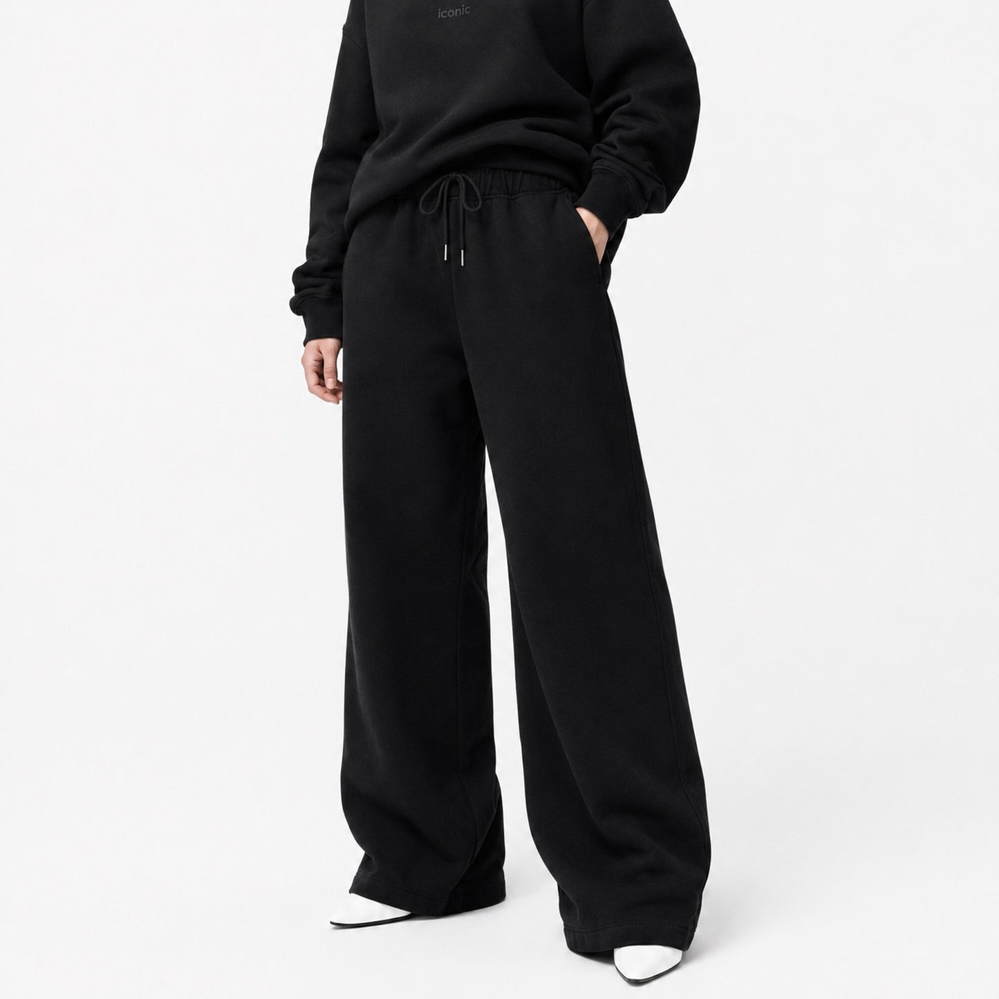 FineAF Iconic black oversized straight-leg pants front view with matching black crewneck and white pointed shoes