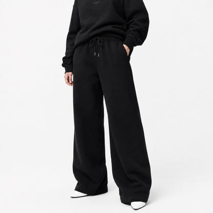 FineAF Iconic black oversized straight-leg pants front view with matching black crewneck and white pointed shoes