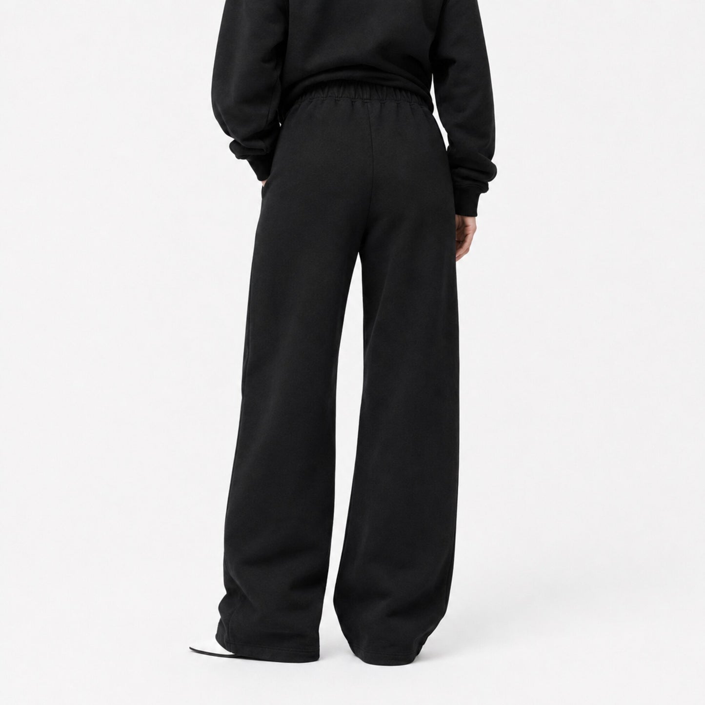 Back view of FineAF Iconic black oversized straight-leg pants with a clean pocket-free back