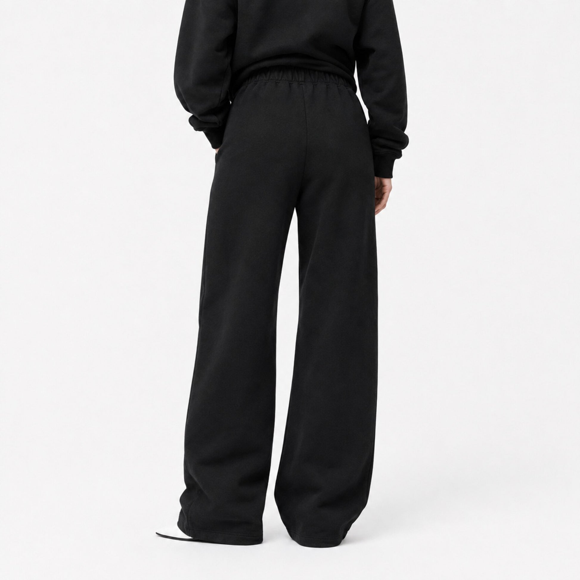 Back view of FineAF Iconic black oversized straight-leg pants with a clean pocket-free back