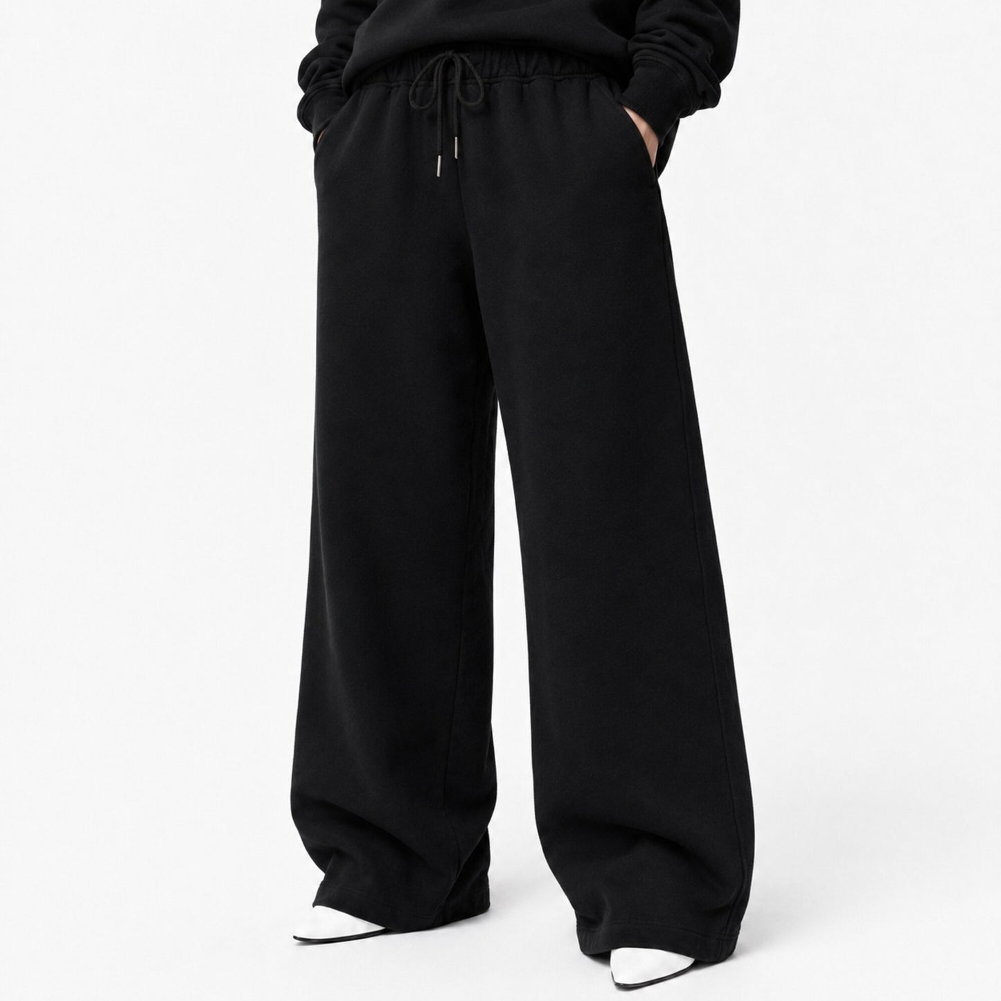 Waist-to-shoe fit view of FineAF Iconic black pants showing the drawcord pockets and wide open legs