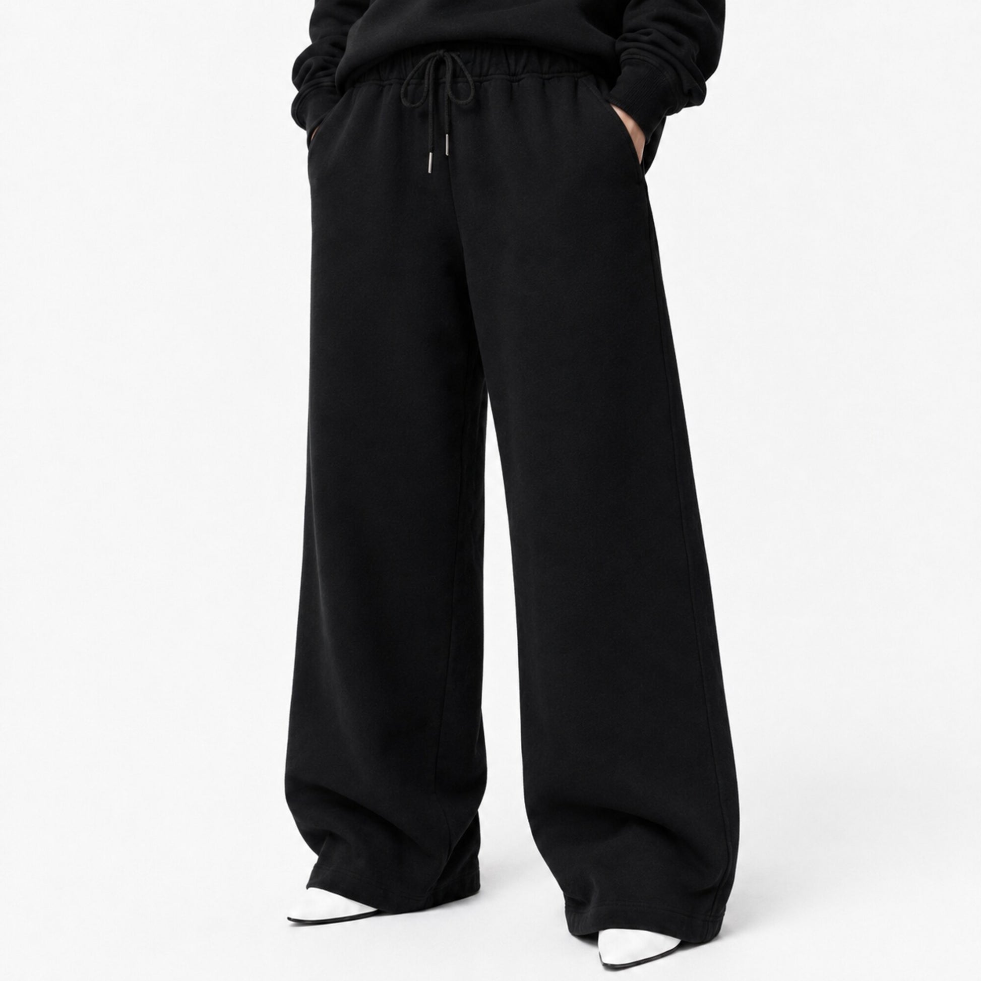 Waist-to-shoe fit view of FineAF Iconic black pants showing the drawcord pockets and wide open legs