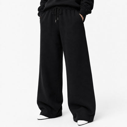 Waist-to-shoe fit view of FineAF Iconic black pants showing the drawcord pockets and wide open legs