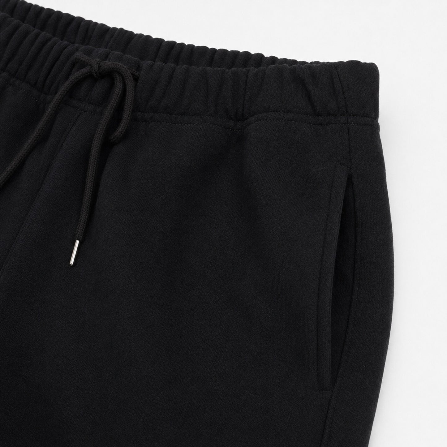 Close-up of the FineAF Iconic black pants elastic waistband drawcord and slanted side pocket