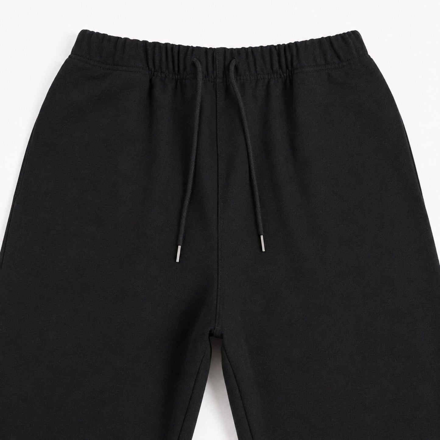 Close-up of the FineAF Iconic black pants front rise seam waistband and upper leg construction
