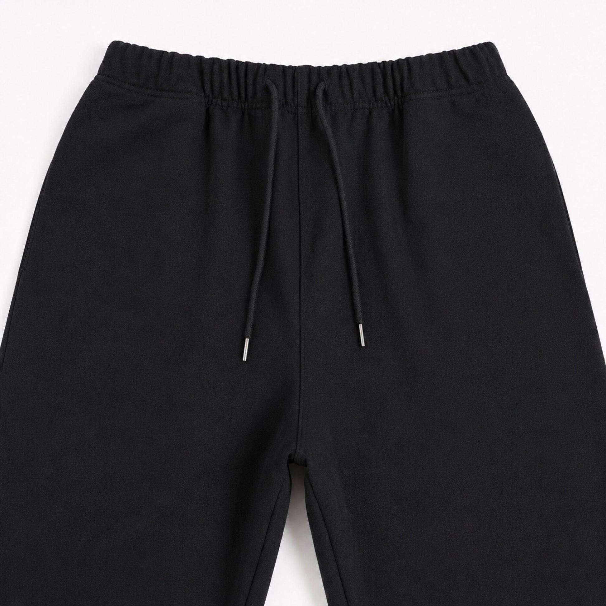 Close-up of the FineAF Iconic black pants front rise seam waistband and upper leg construction