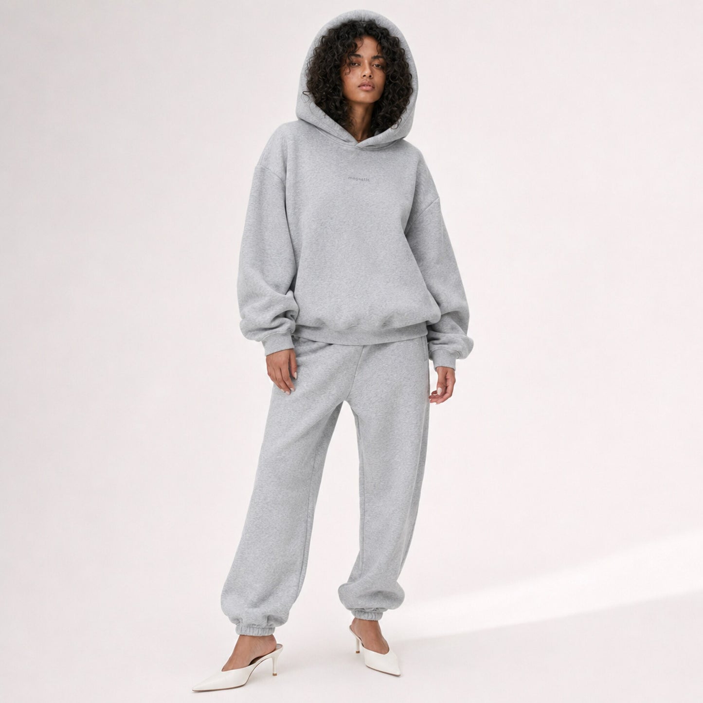 Model wearing the structured hood up on the FineAF Magnetic heather grey oversized hoodie