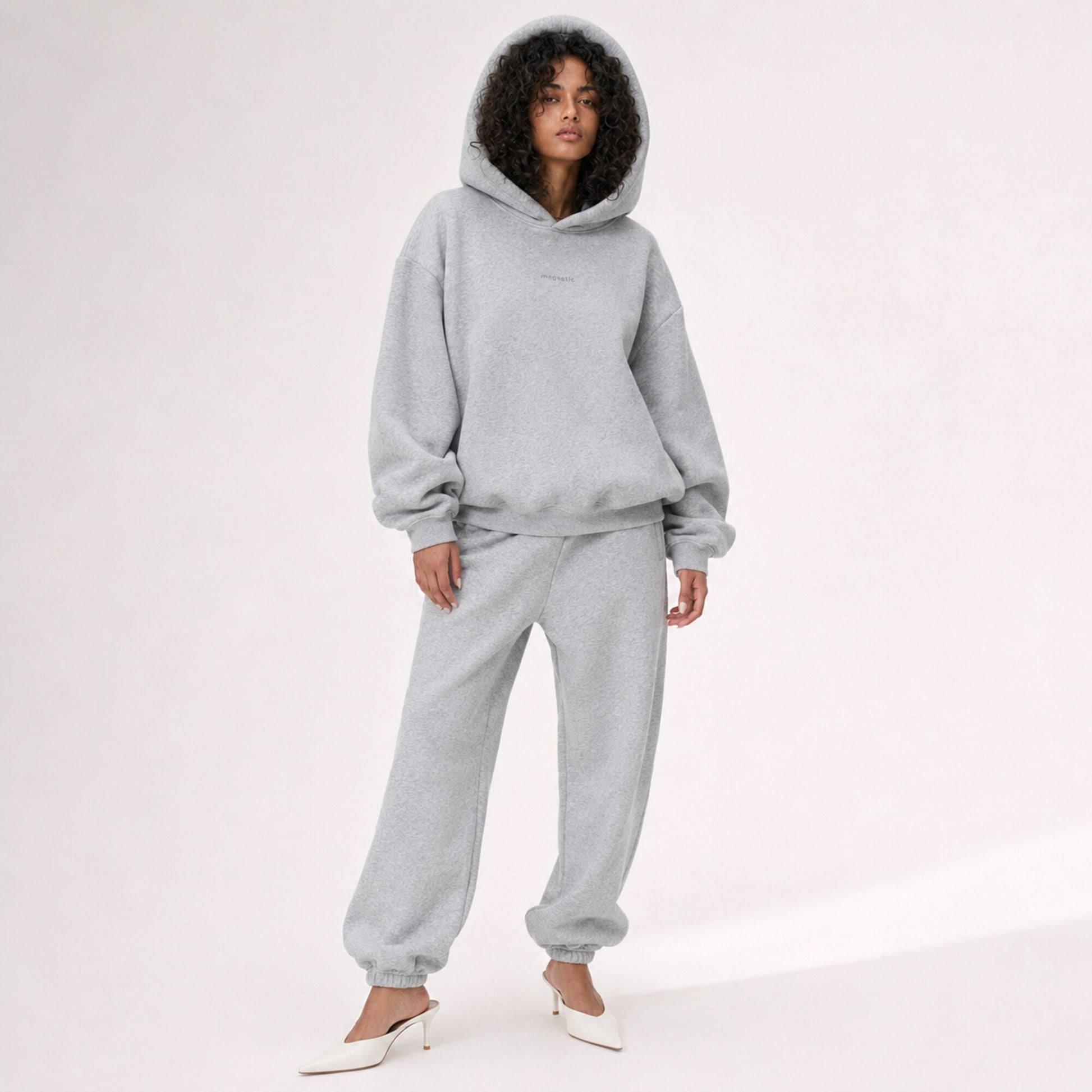 Model wearing the structured hood up on the FineAF Magnetic heather grey oversized hoodie