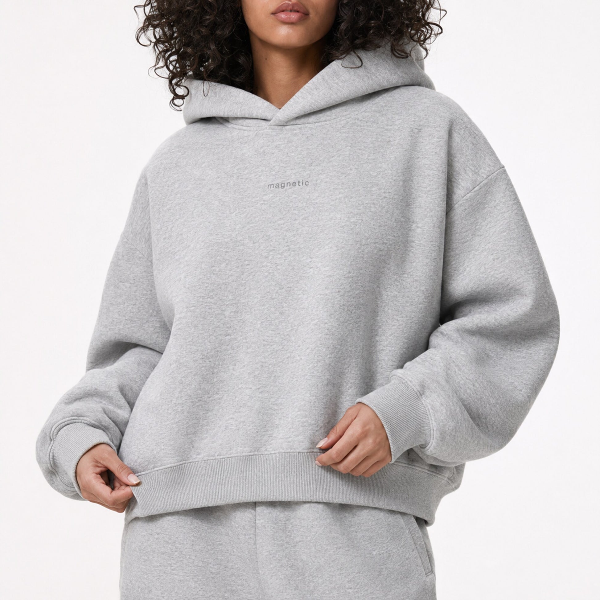 Close model view of the FineAF Magnetic hoodie showing the tonal chest design, ribbing and heavyweight grey fleece