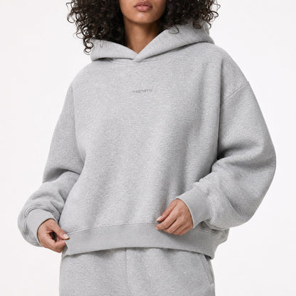 Close model view of the FineAF Magnetic hoodie showing the tonal chest design, ribbing and heavyweight grey fleece