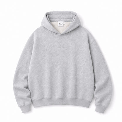 Front flat lay of the FineAF Magnetic heather grey hoodie with tonal magnetic chest design and FineAF neck label