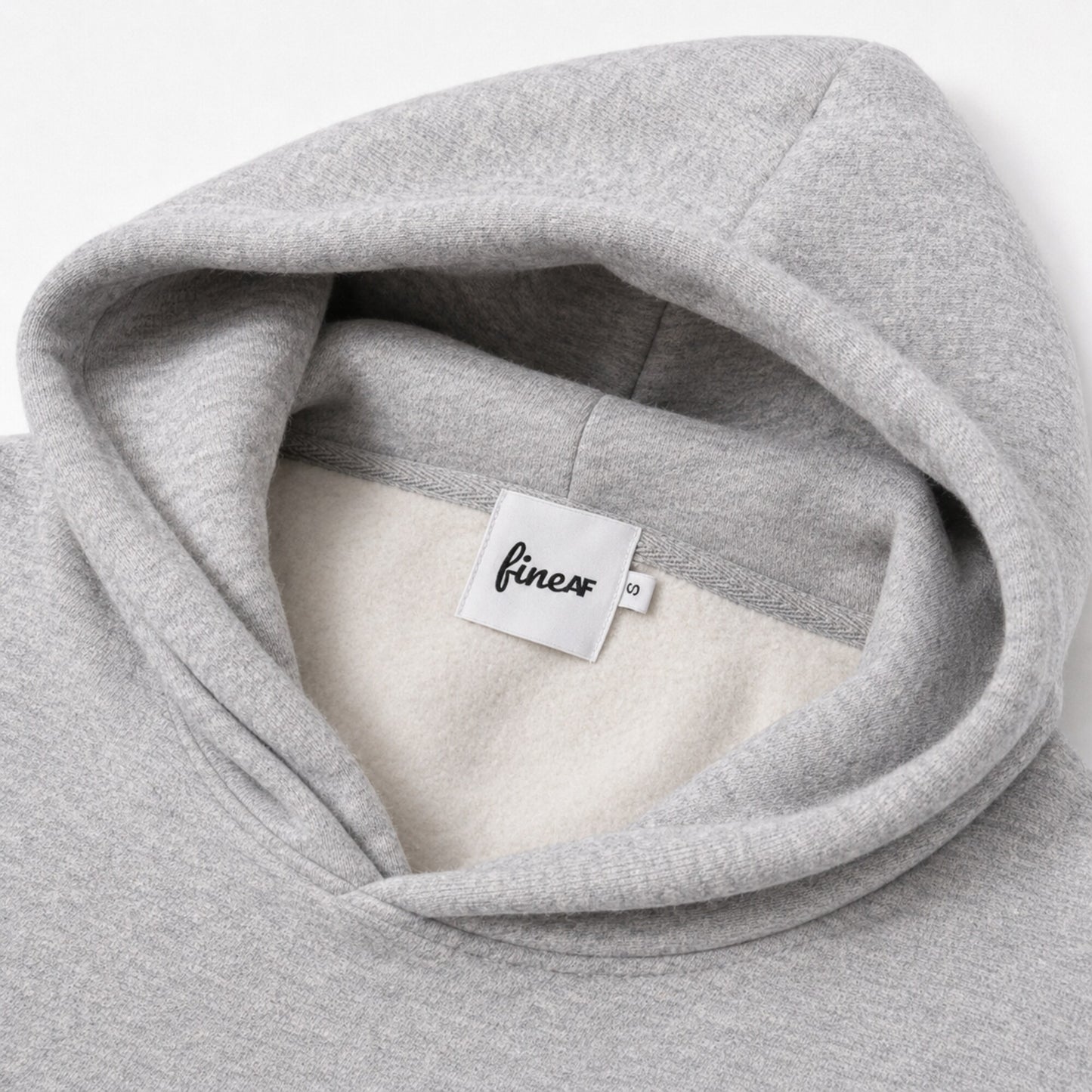 Close-up of the FineAF Magnetic hoodie interior, brushed fleece, white FineAF neck label and size tab