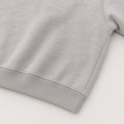 Close-up of the continuous ribbed hem and closed side construction on the FineAF Magnetic grey hoodie