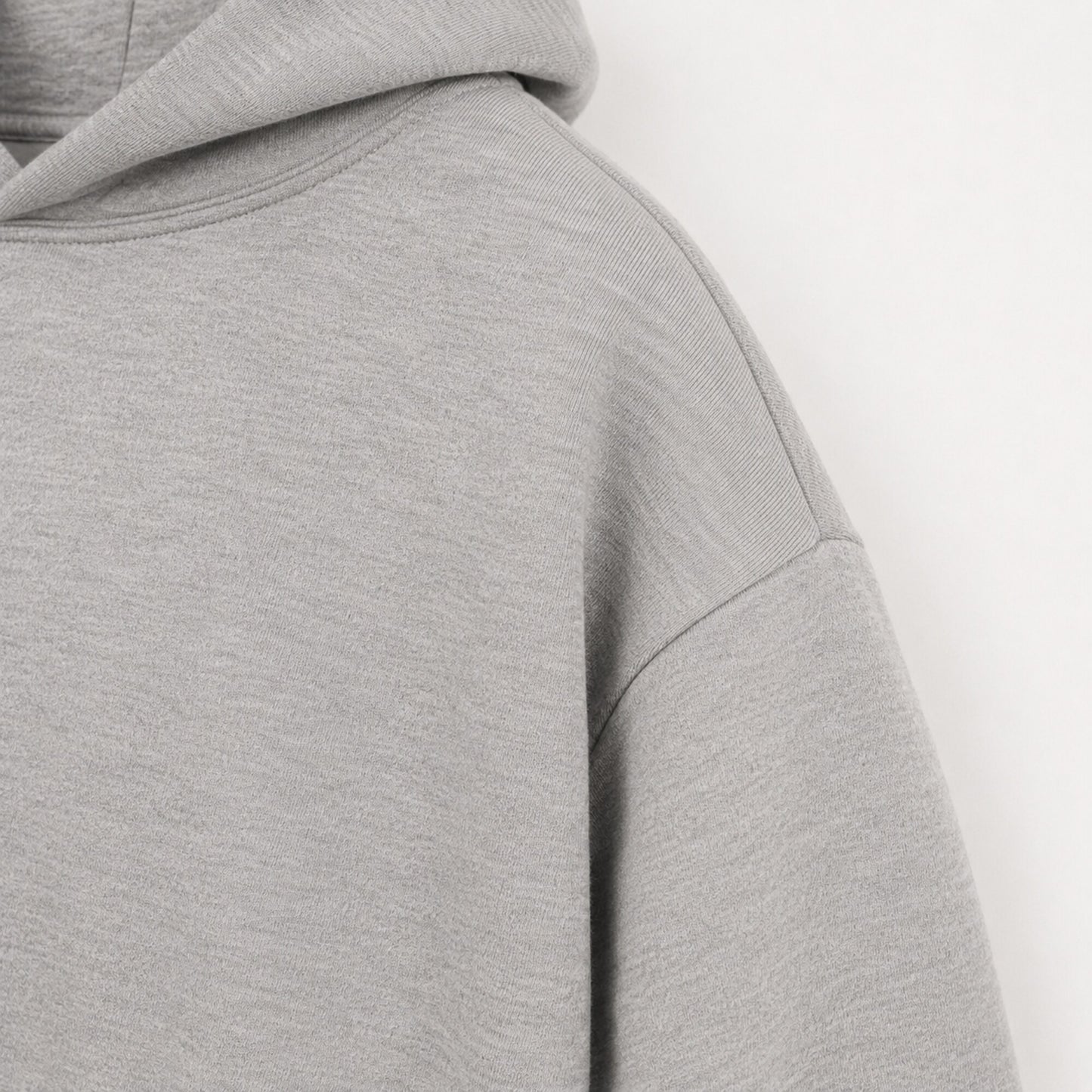 Close-up of the dropped shoulder seam on the FineAF Magnetic heather grey hoodie