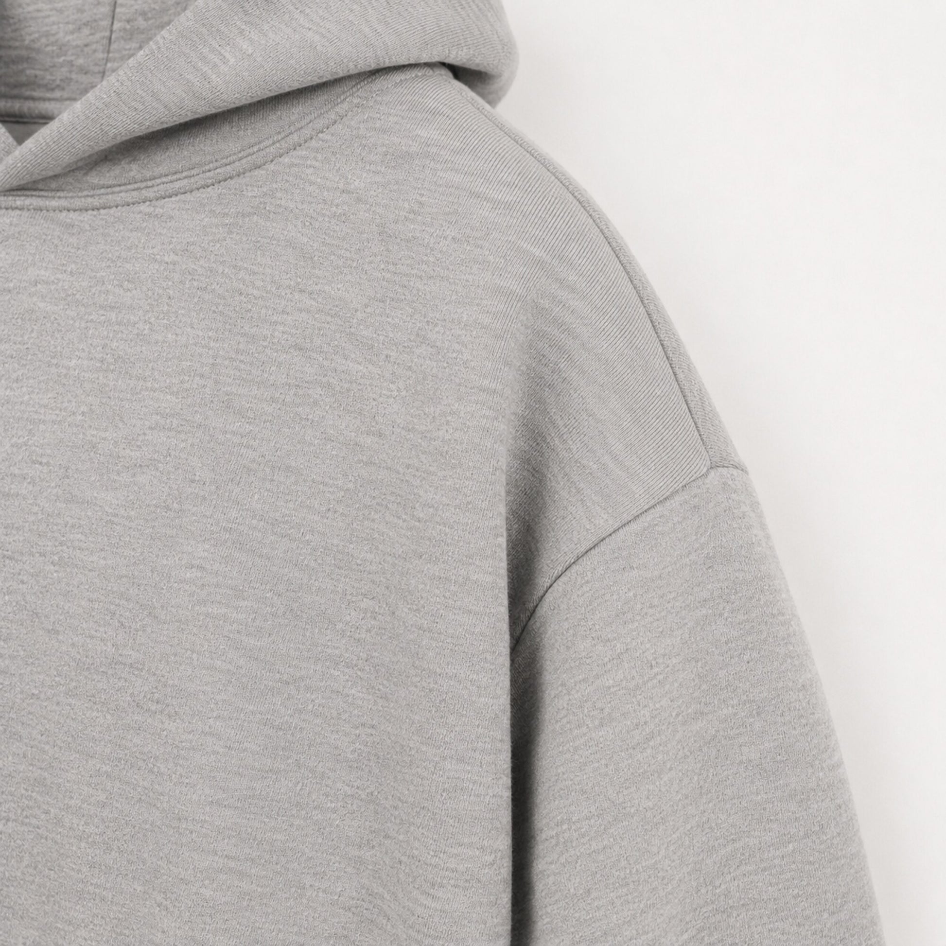 Close-up of the dropped shoulder seam on the FineAF Magnetic heather grey hoodie