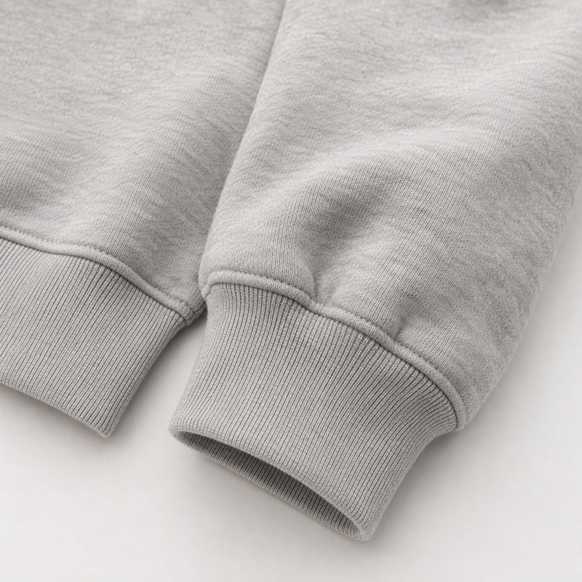 Close-up of the heavyweight sleeve and ribbed cuff on the FineAF Magnetic heather grey hoodie